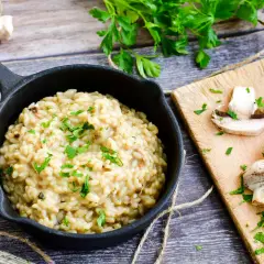 Kremowe risotto z grzybami, posypane natką pietruszki. Idealny risotto przepis podstawowy na pyszny obiad.