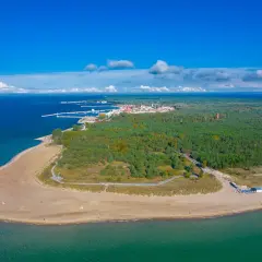 Widok z lotu ptaka na Półwysep Helski, gdzie leży Jastarnia. Piękna plaża, las i port w oddali.