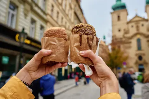 Praga co zjeść? Dwa tradycyjne trdelniki, jeden w cukrze, drugi w czekoladzie z orzechami, idealne na spacer po Starym Mieście.